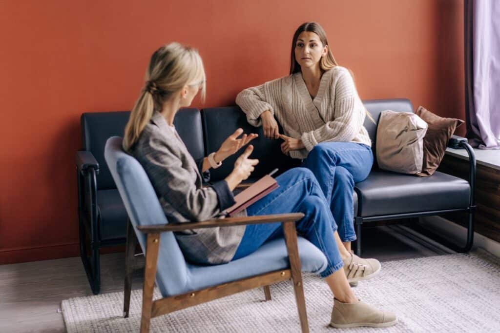 Client and health practitioner sitting together in a supportive consultation, discussing next steps in a personalized care plan for managing Type 1 diabetes and improving overall well-being.